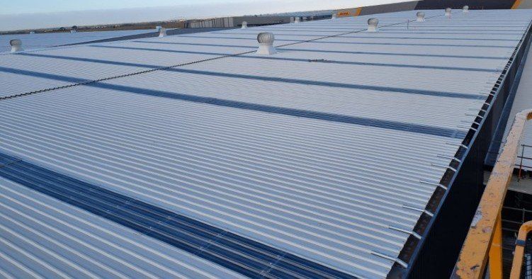 Kliplok Zincalume metal roof sheeting and vertical Colorbond cladding installation, Truganina logistics hub